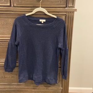 Deep navy sweater. Slight puff at the elbow to the wrist.